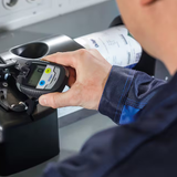 A Drager CO Single Gas Detector being placed into a Drager brand docking station